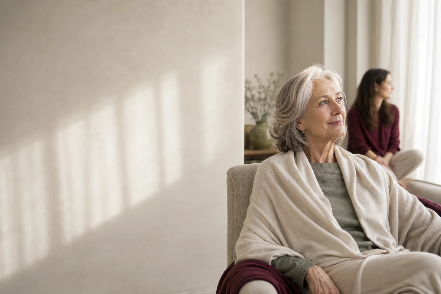 An older woman at home, looking directly at the camera